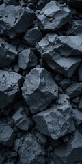 A close-up view of rough, dark gray rocks piled together.