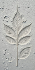 A textured relief of a leaf design on a light background.