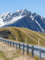 Serene mountain vista unfolds along a winding road bathed in bright sunlight. AI Generated