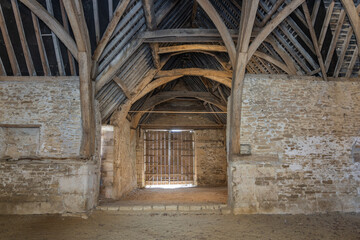 Ancient building technique stone walls and curved roof beams and trusses
