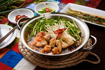 Fish stew topped with vegetables, mushrooms and sliced ​​red peppers