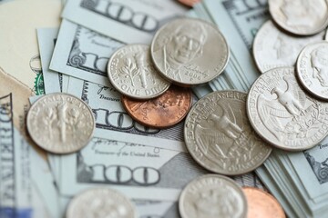 Many hundred dollar bills and US cents coins. Different coins and banknotes.