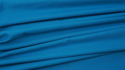 Obraz premium Close-up of blue cotton fabric showing a detailed woven texture, soft natural fibers, and a smooth textile surface perfect for design or background use.