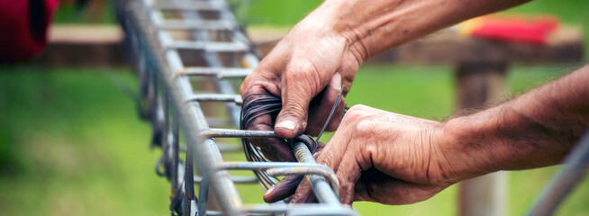 Banner Construction Worker hands using pincer pliers iron wire. Outdoor Worker using wire bending...