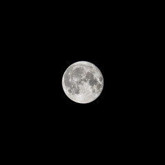 Detailed image of the full moon isolated on black.