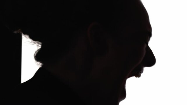 Screaming silhouette. Mental disorder. Nervous breakdown. Emotional crisis. Dark contrast profile of frustrated woman yelling isolated on white free space background.