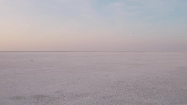 4K Aerial shot of salt flats at rann of Kutch during sunrise. White desert of Kutch in Gujarat, India. Aerial view over the expansive salt marsh of The Great Rann of Kutch. Tranquil Nature landscape. 