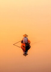 Obraz premium Eco-Conscious Fishing Traditional Asian Fisherman in Sunrise Reflections on Wooden Boat - Sustainable Seafood and Ocean Conservation Branding