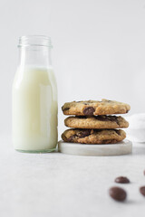 Large chocolate chip cookies on a white countertop, top view of homemade chocolate chip cookies on a white background