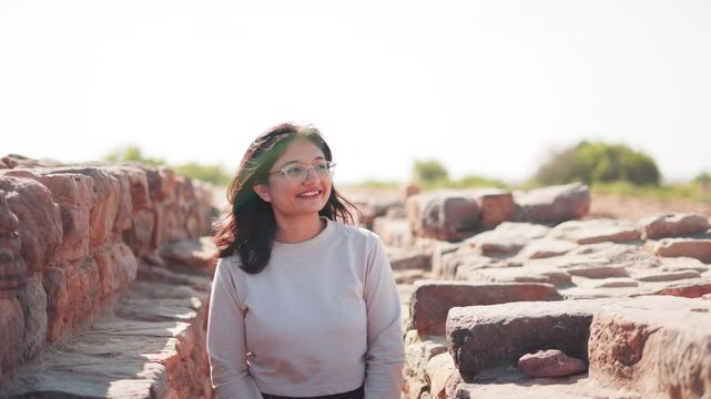 Indian woman exploring ruins of Dholavira Harappan Civilization at Kutch, Gujarat, India. The ancient city of Dholavira UNESCO World Heritage Centre. Archaeological site of Indus valley civilization.