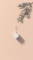 A minimalist composition featuring a hexagonal object hanging against a soft pink background, complemented by a delicate green leaf.