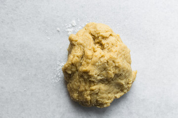 Nigerian Chin chin dough on a white granite countertop, Raw chin-chin on a chopping board, process of making chin chin achomo or klenat