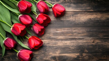 Rich red tulips with green stems rest on a rustic dark wood surface — romantic, elegant arrangement perfect for Valentine’s Day, anniversaries, or spring-themed designs.