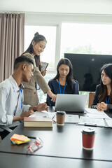 Asian senior office worker teach intern students doing work