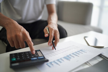 Man using calculator calculate finance and another hand holding pen