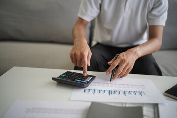 Man using calculator calculate finance and another hand holding pen