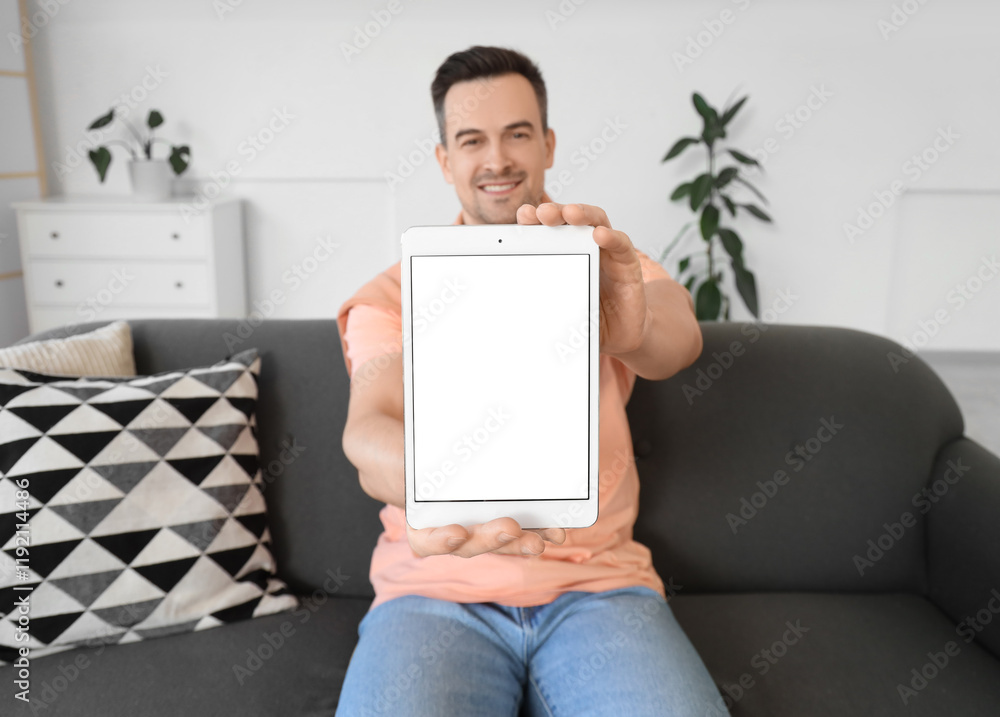 Poster man with tablet computer sitting on sofa. mockup for design