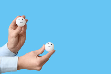 Man holding rating smiles on blue background. Survey concept