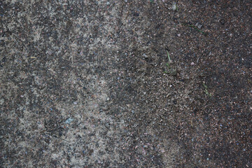 Textured Surface of Ground Featuring Distinct Dark and Light Variations and Patterns