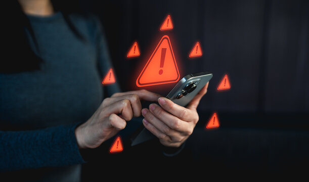 Businessman or programmer, developer using computer laptop with triangle caution warning sign for notification error and maintenance concept. Virus detected warning, Cybercrime protection. - Powered by Adobe
