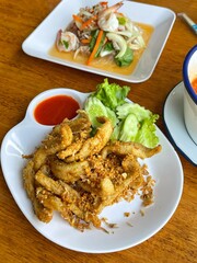 Crispy fried river fish in Thailand. Fried fish refers to any fish or shellfish that has been prepared by frying. Often, the fish is covered in batter, or flour, or herbs and spices before being fried