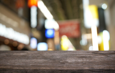 Empty wood table top and blur of restaurant background selective focus product display