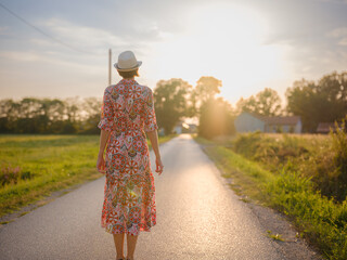 boho chic woman in a floral dress in European countryside