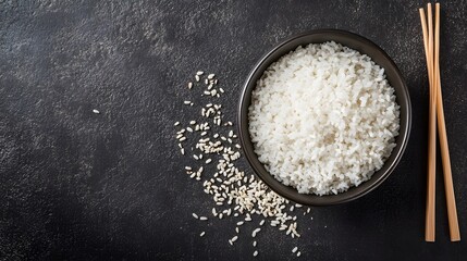 Bowl of Cooked White Rice with Chopsticks and Grains