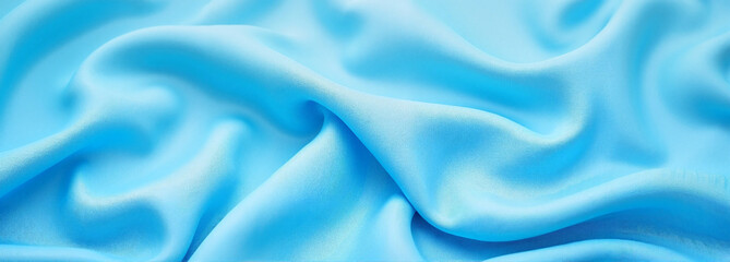 Obraz premium Flowing blue silk fabric with soft folds and textures