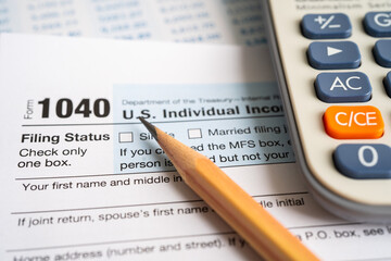 Tax Return form 1040 with pencil and calculator, U.S. Individual Income.