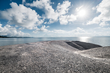 Coastal landscape with sand terrain and bright sky. Outdoor natural background.