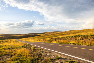 Asphalt road highway and beautiful grassland nature landscape in autumn season. Outdoor road background.