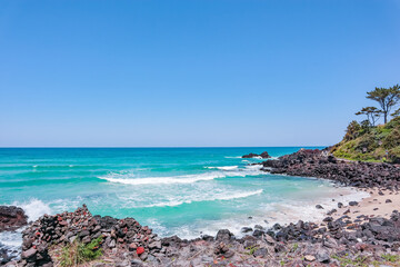Korean Beach Sea A beautiful beach with a blue ocean and a rocky shore
