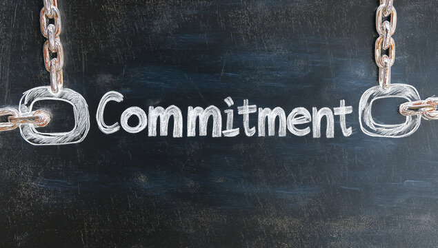 A chain with the word commitment written on it