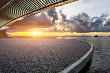 Asphalt road and bridge with beautiful coastline scenery at sunset. Outdoor natural background.