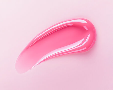 Lip gloss swatch on soft pink background. Close-up of liquid lipstick, glossy texture, horizontal flatlay. Professional studio light