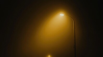 Street lamps glowing in fog during nighttime creating eerie ambiance