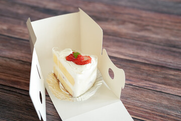 Japanese shortcake with strawberries on top is placed on wooden floor