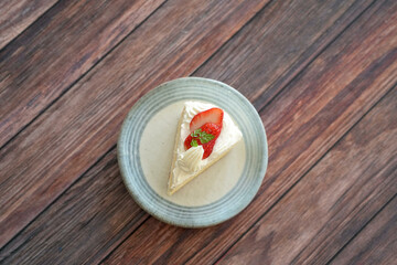 Japanese shortcake with strawberries on top is placed on wooden floor
