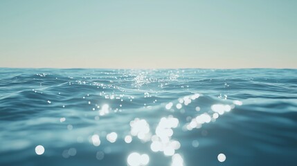 Blue ocean under clear sky with sunlight reflections