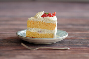 Japanese shortcake with strawberries on top is placed on wooden floor
