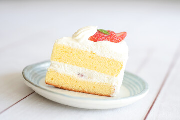 Japanese shortcake with strawberries on top is placed on a white wooden floor