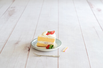 Japanese shortcake with strawberries on top is placed on a white wooden floor