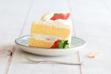 Japanese shortcake with strawberries on top is placed on a white wooden floor
