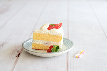 Japanese shortcake with strawberries on top is placed on a white wooden floor