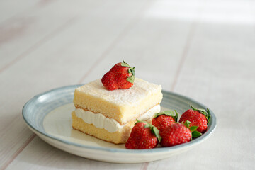 Japanese shortcake with strawberries on top is placed on a white wooden floor