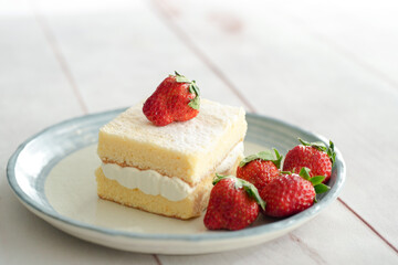 Japanese shortcake with strawberries on top is placed on a white wooden floor