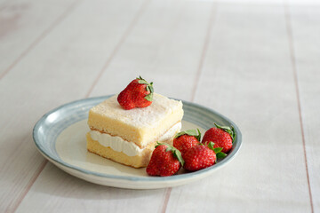 Japanese shortcake with strawberries on top is placed on a white wooden floor