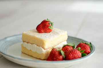 Japanese shortcake with strawberries on top is placed on a white wooden floor