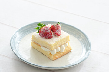 Japanese shortcake with strawberries on top is placed on a white wooden floor